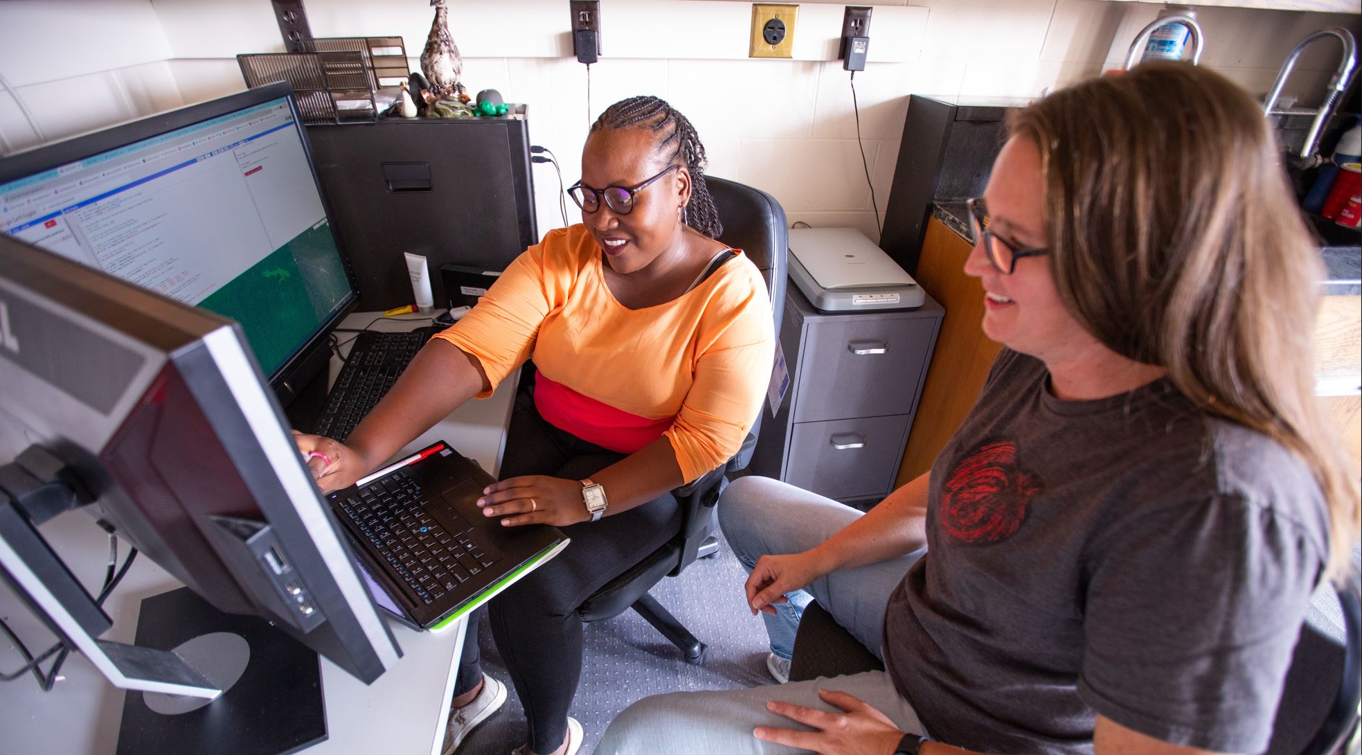 two women looking at computer screens