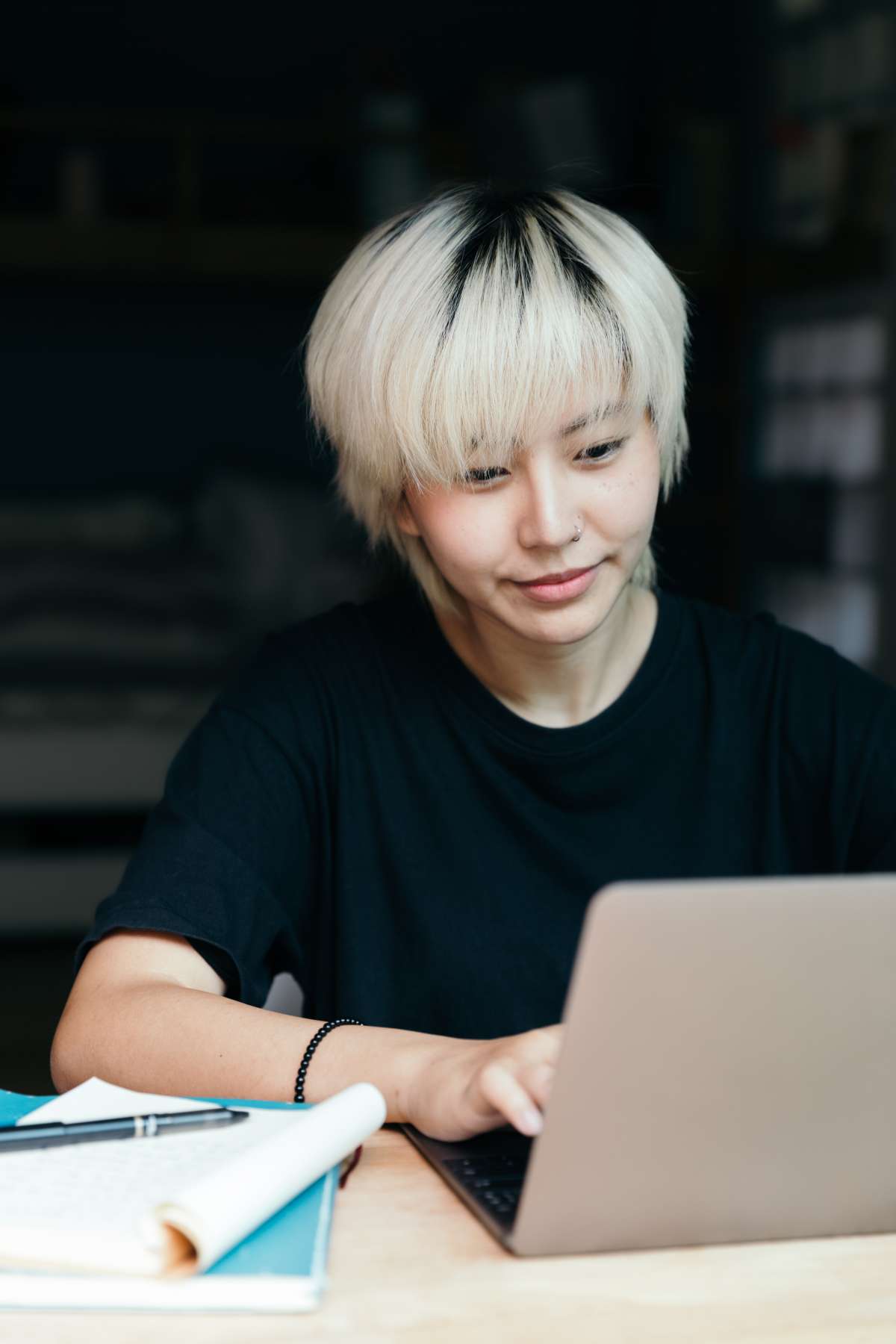 young-ethnic-woman-using-laptop-in-workspace