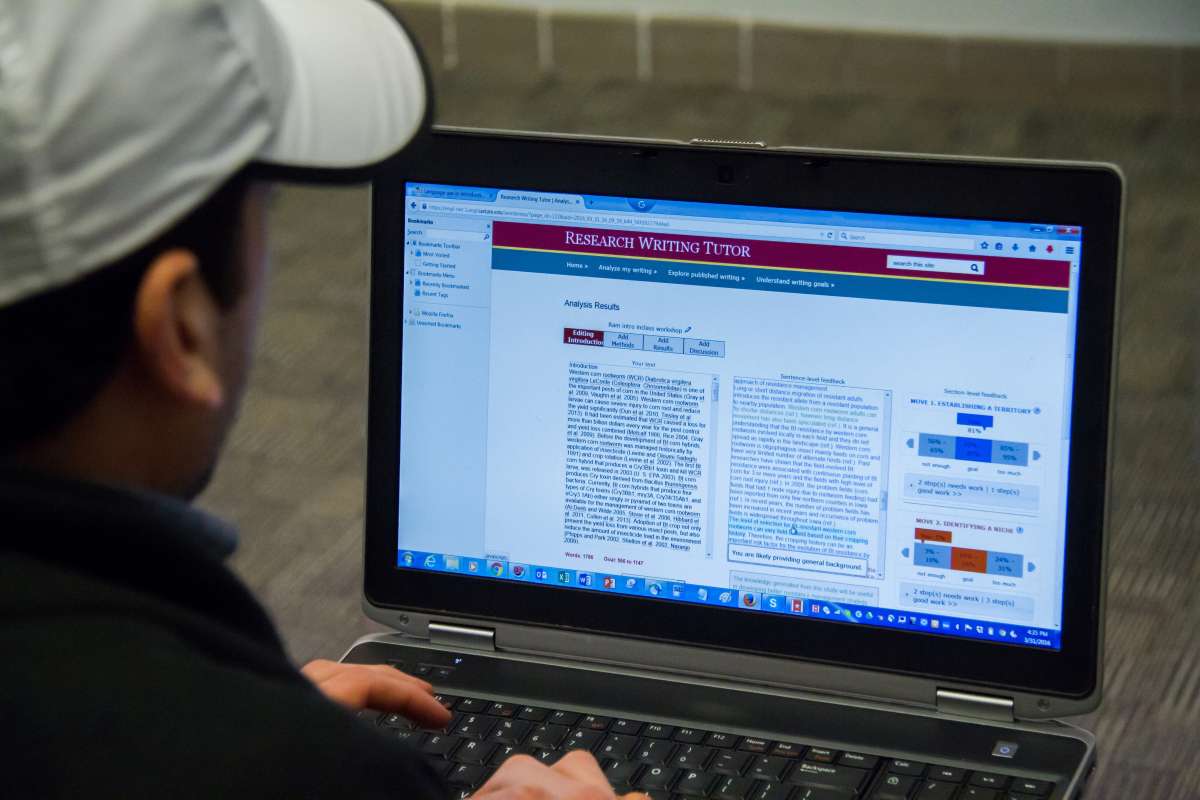 A graduate student uses the Research Writing Tutor on his laptop